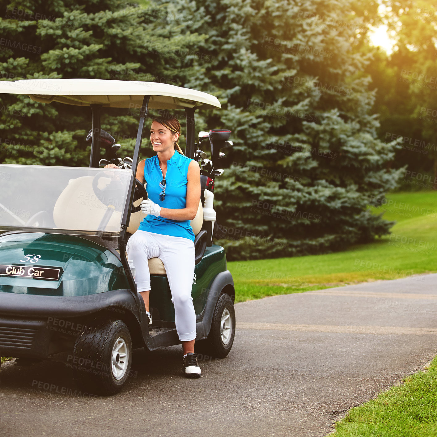 Buy stock photo Full length shot of an attractive young woman sitting in a golf cart on a golf course