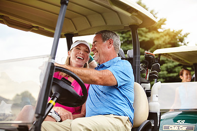 Buy stock photo Shot of an affectionate mature couple spending a day on the golf course