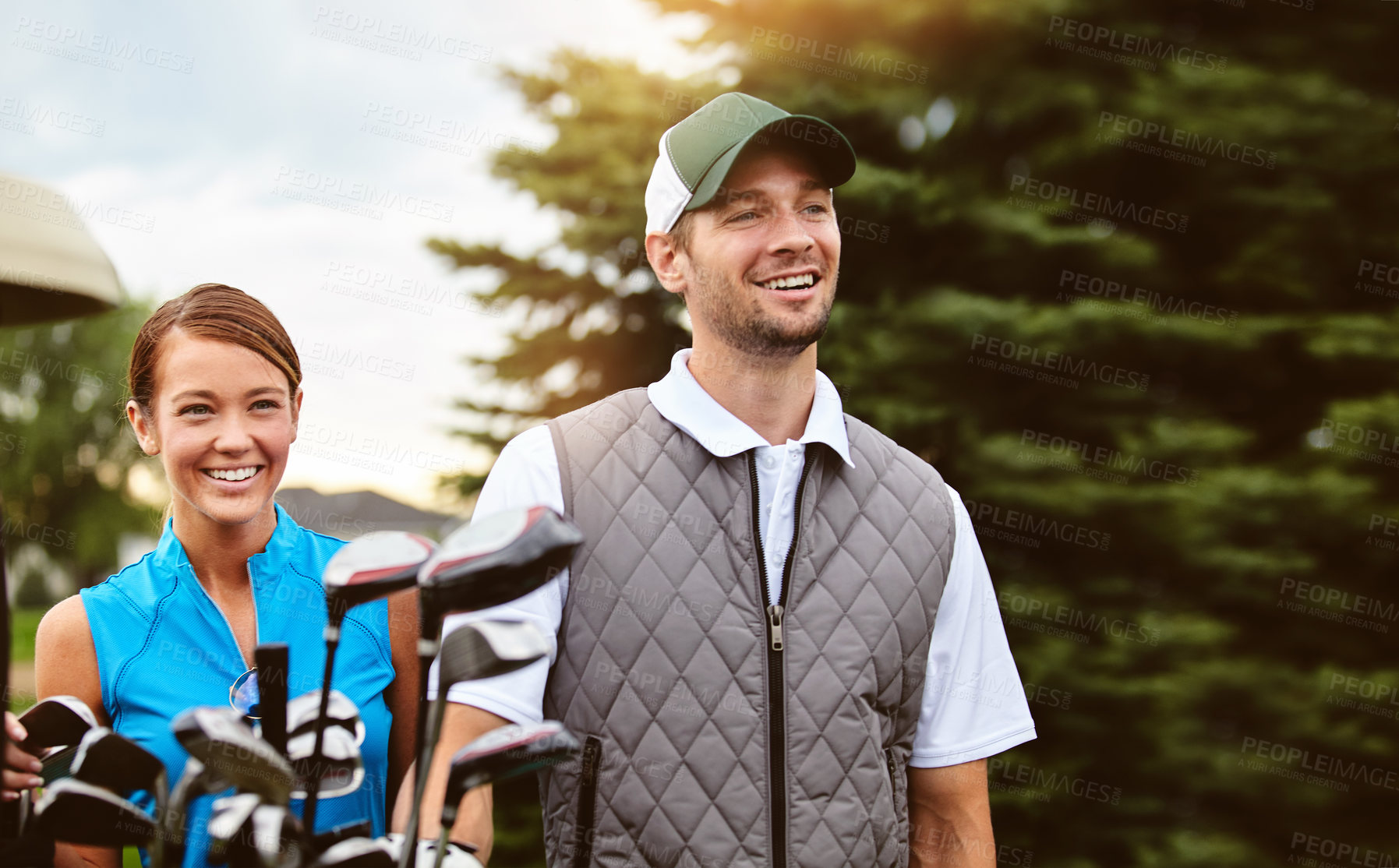 Buy stock photo Shot of an affectionate young couple spending a day on the golf course