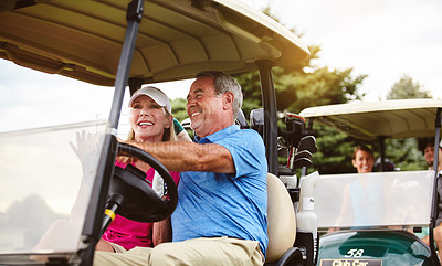 Buy stock photo Shot of an affectionate mature couple spending a day on the golf course