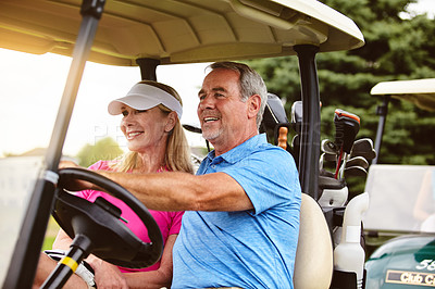 Buy stock photo Shot of an affectionate mature couple spending a day on the golf course