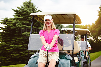 Buy stock photo Cropped portrait of an attractive mature woman leaning against a golf cart on a golf course