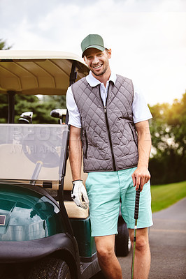 Buy stock photo Cropped portrait of a handsome young man leaning against a golf cart on a golf course