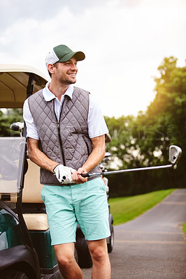 Buy stock photo Cropped shot of a handsome young man leaning against a golf cart on a golf course