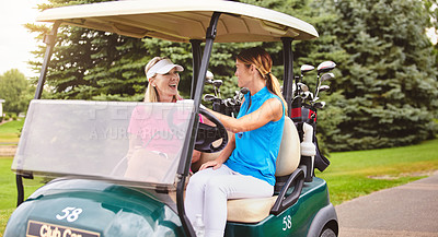 Buy stock photo Cropped shot of an attractive young woman and her mother driving a golf cart on a golf course