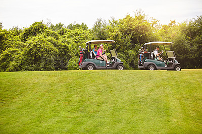 Buy stock photo Shot of two couples with golf carts spending a day on the golf course