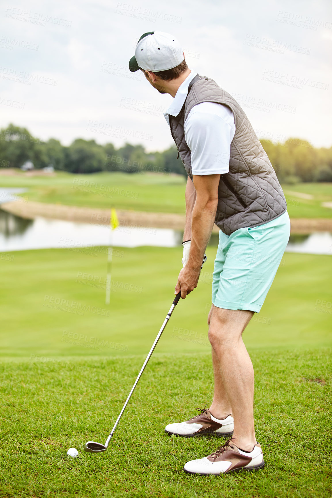 Buy stock photo Full length shot of a handsome young man playing a round of golf on a golf course