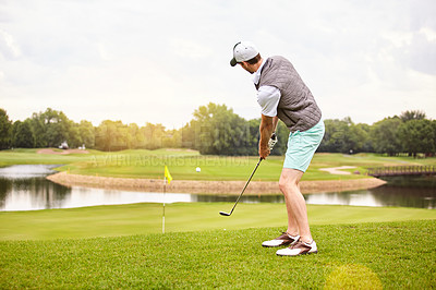 Buy stock photo Full length shot of a handsome young man playing a round of golf on a golf course
