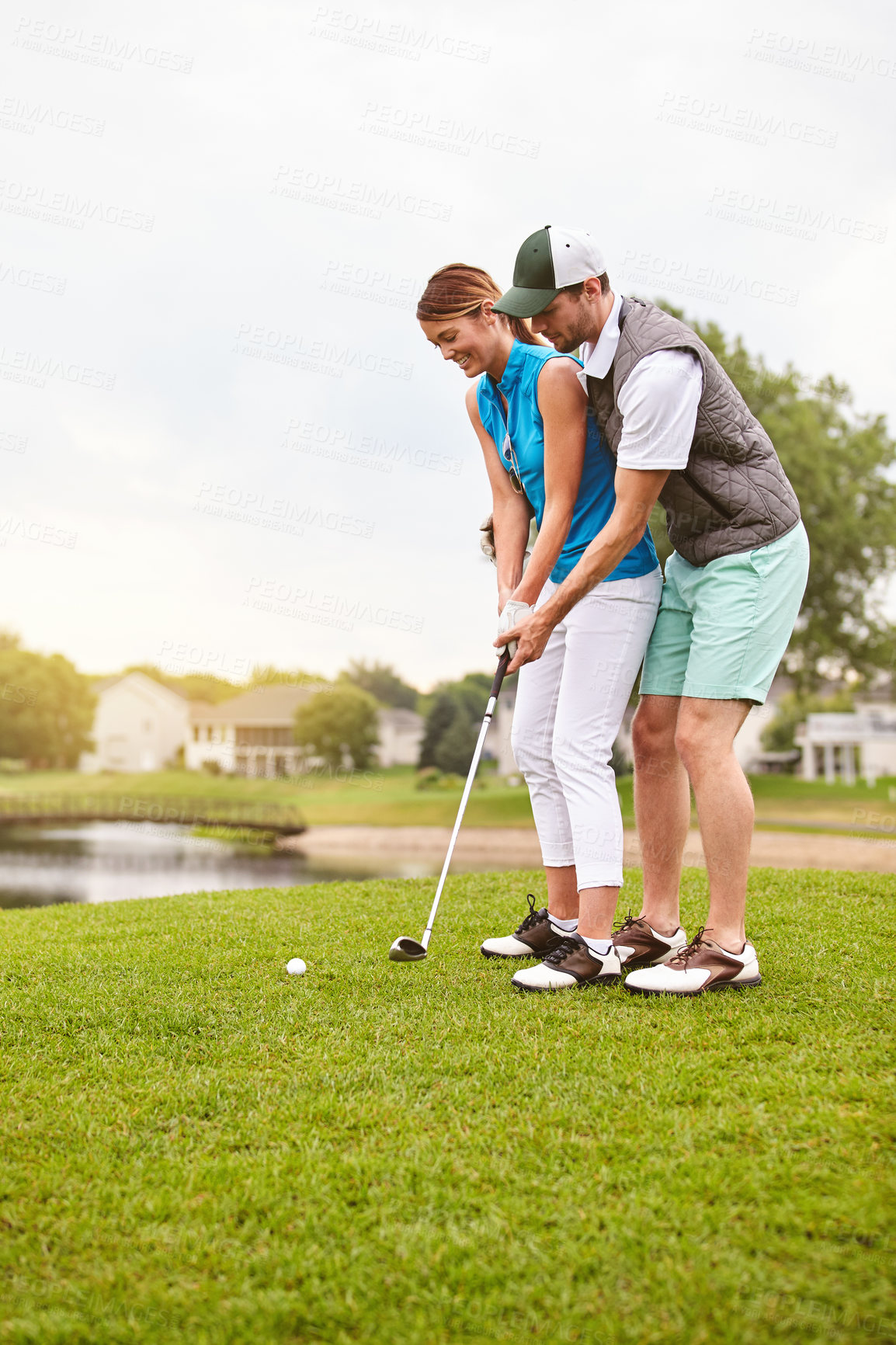 Buy stock photo Couple, help and happy at golf course with bonding on vacation, space and guide for swing in summer. People, partner and smile on getaway at country club with sports gear, aim or coaching on holiday