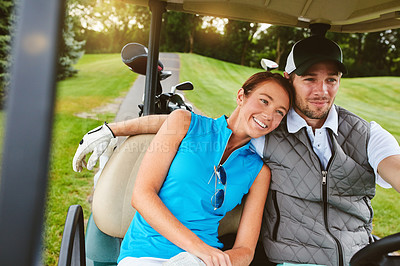 Buy stock photo Shot of an affectionate young couple spending a day on the golf course