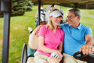 Buy stock photo Shot of an affectionate mature couple spending a day on the golf course