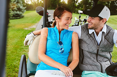 Buy stock photo Shot of an affectionate young couple spending a day on the golf course