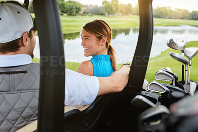 Buy stock photo Shot of an affectionate young couple spending a day on the golf course