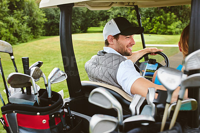 Buy stock photo Shot of an affectionate young couple spending a day on the golf course