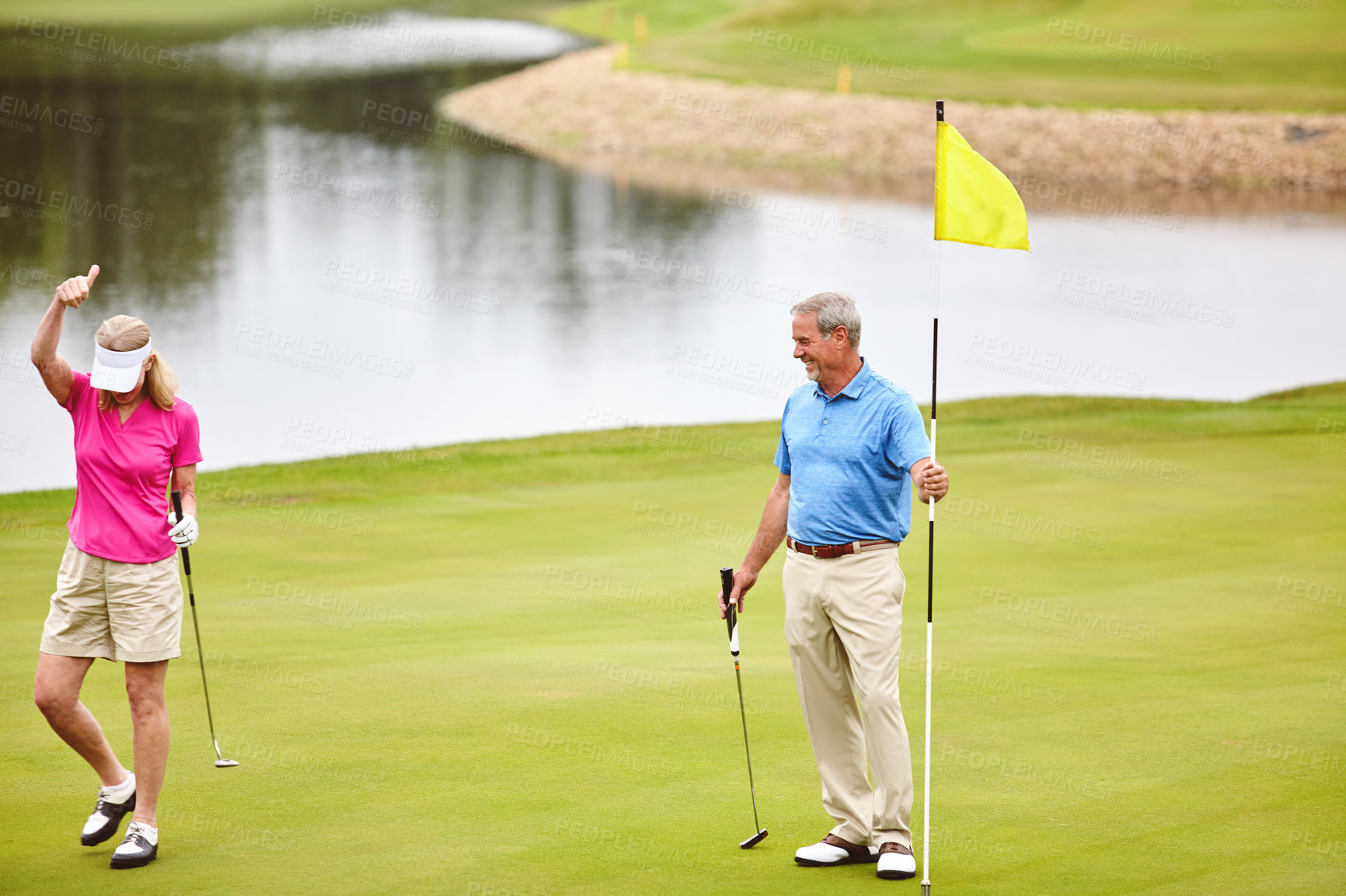 Buy stock photo Golf, game and mature couple outdoor ready for fitness challenge, sport swing or support of shot aim practice. Smile, man and woman with club, bonding and retirement on turf course for competition