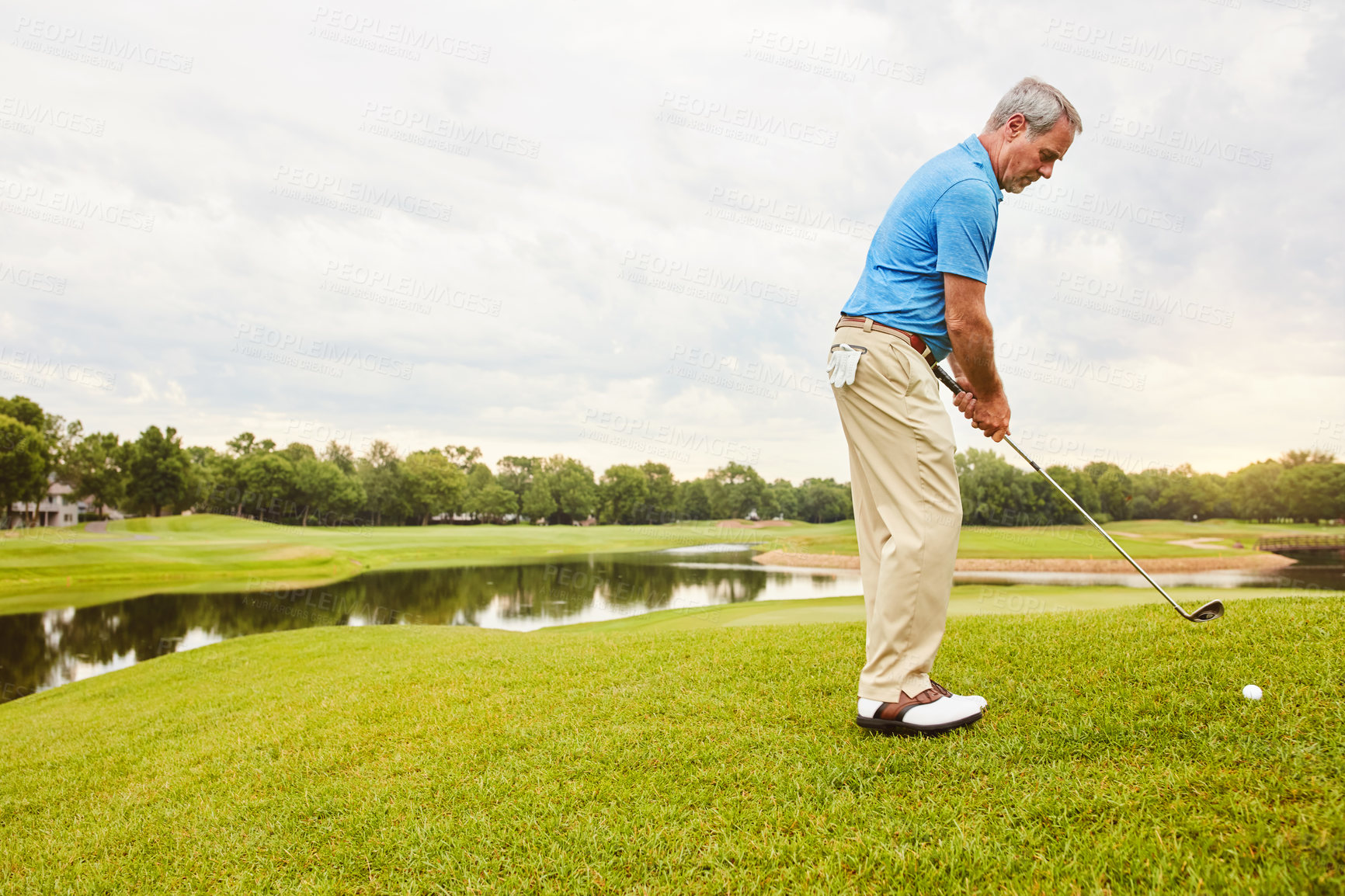 Buy stock photo Mature, man and swing on grass for golf or ball to improve balance with coordination and retirement leisure. Golfer, club and play on field for physical activity, mobility and outdoor sport.