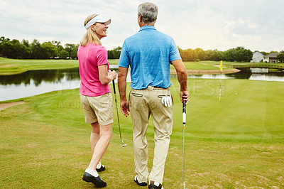 Buy stock photo Club, mature couple and walking for golf game outdoor, talking and sports support of recreation practice. Woman, man and love for hobby lesson, advice and discussion of retirement activity in nature