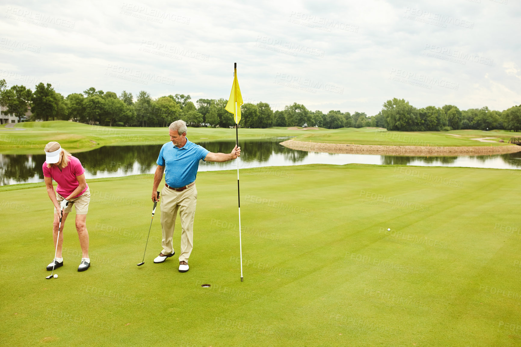 Buy stock photo Shot of a mature couple out playing golf together