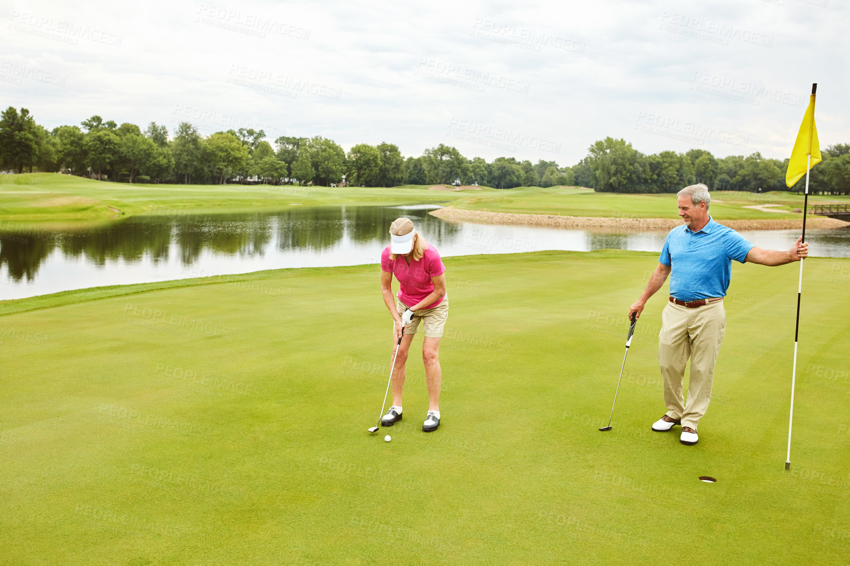 Buy stock photo Golf, mature couple and swinging sport outdoor, shooting advice and technique of training skill for fitness. Woman, discussion and man with flag location, game practice and placement for competition
