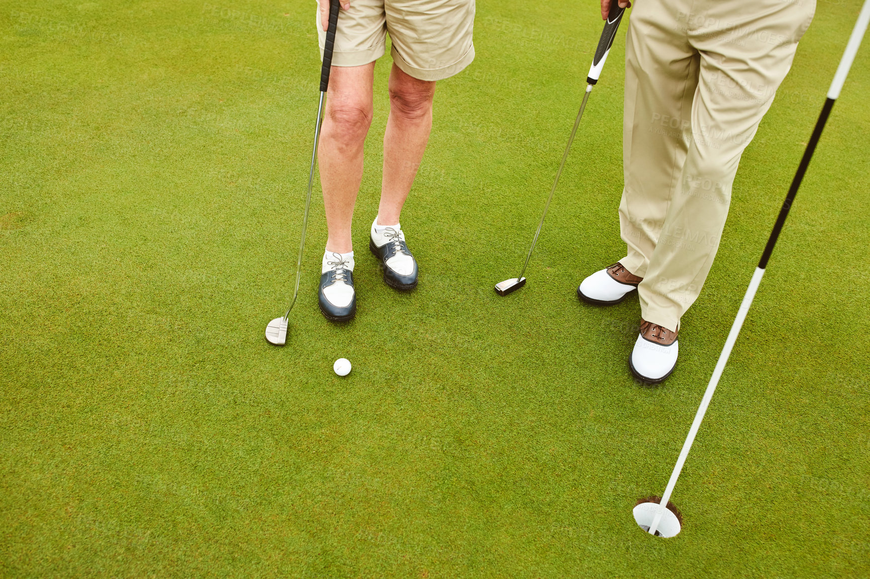 Buy stock photo Cropped shot of two unrcognizable people playing golf together