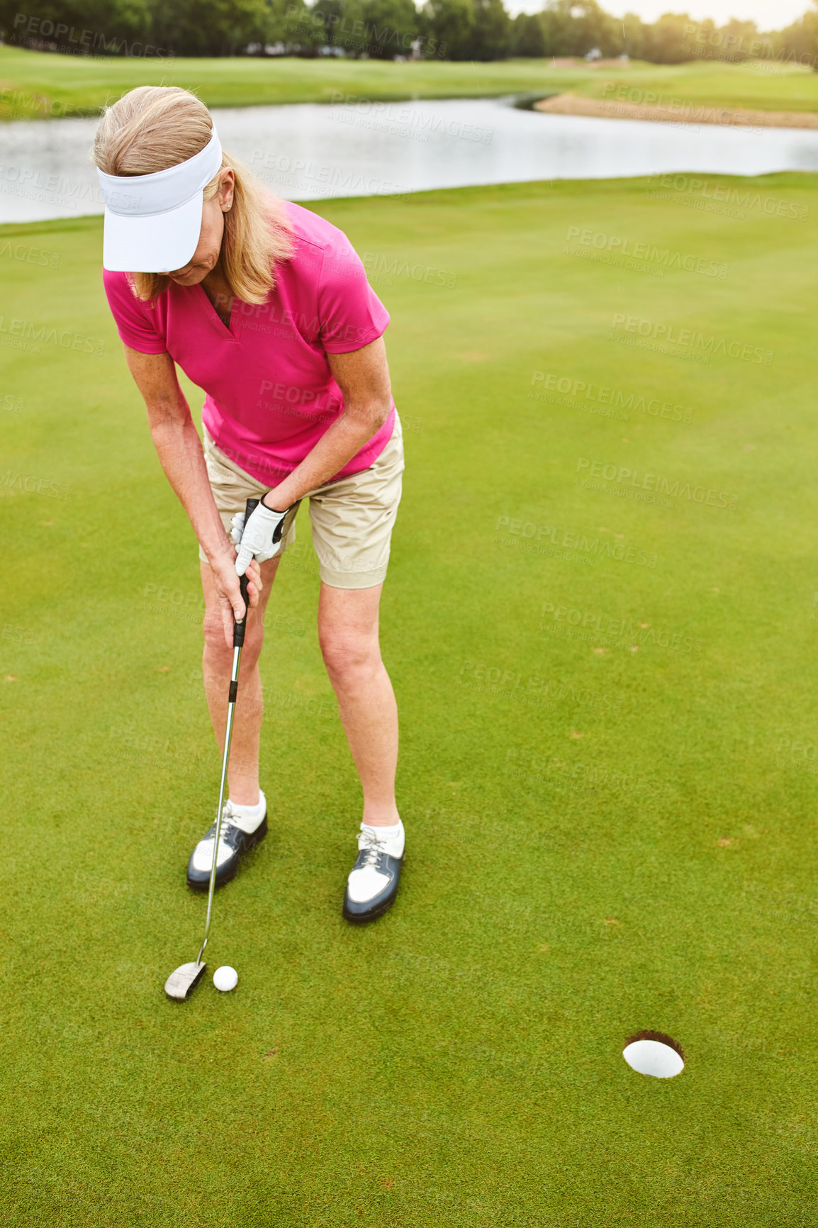 Buy stock photo Full length shot of a mature woman out playing golf on a golf course