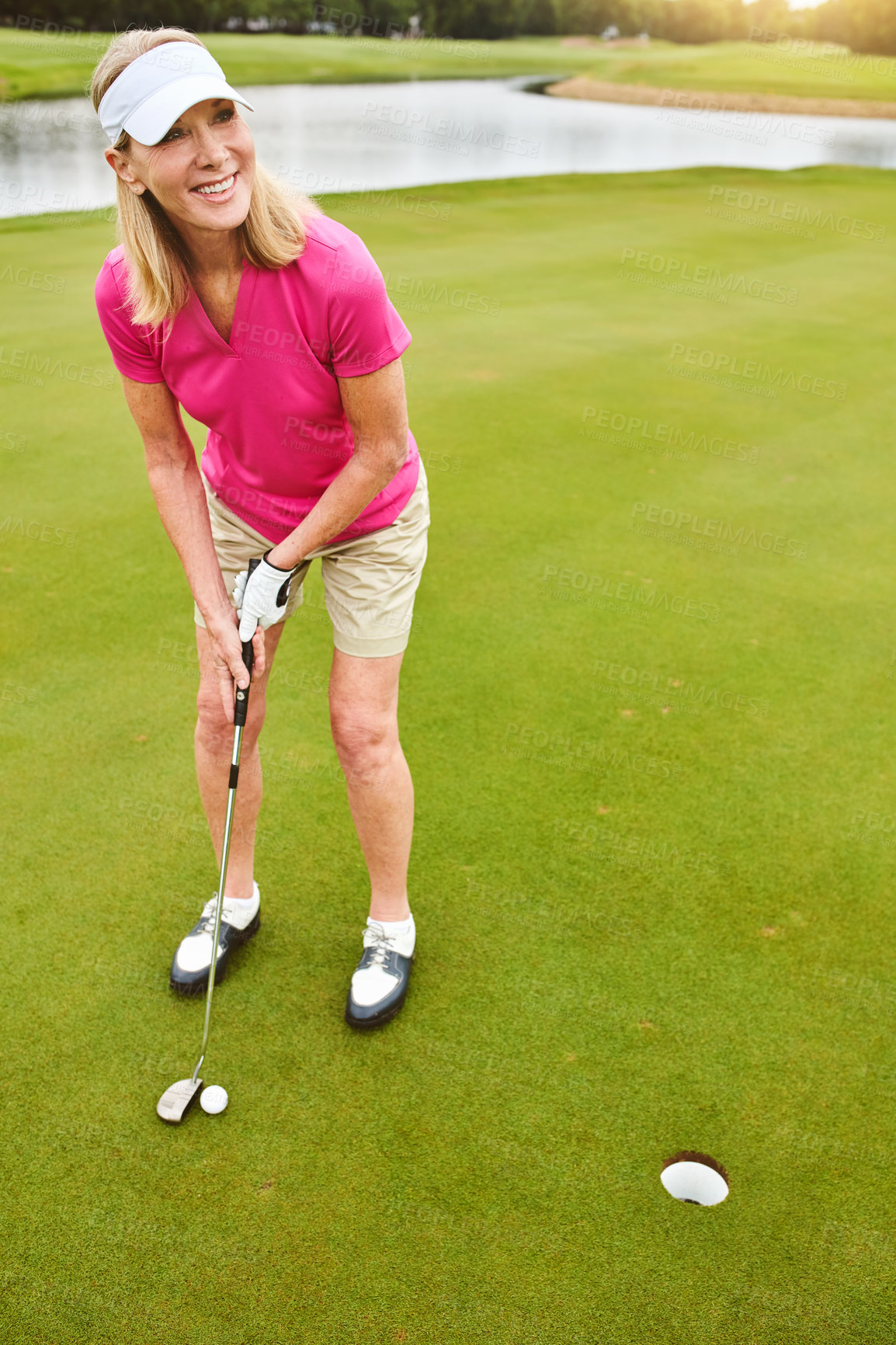 Buy stock photo Full length shot of a mature woman out playing golf on a golf course