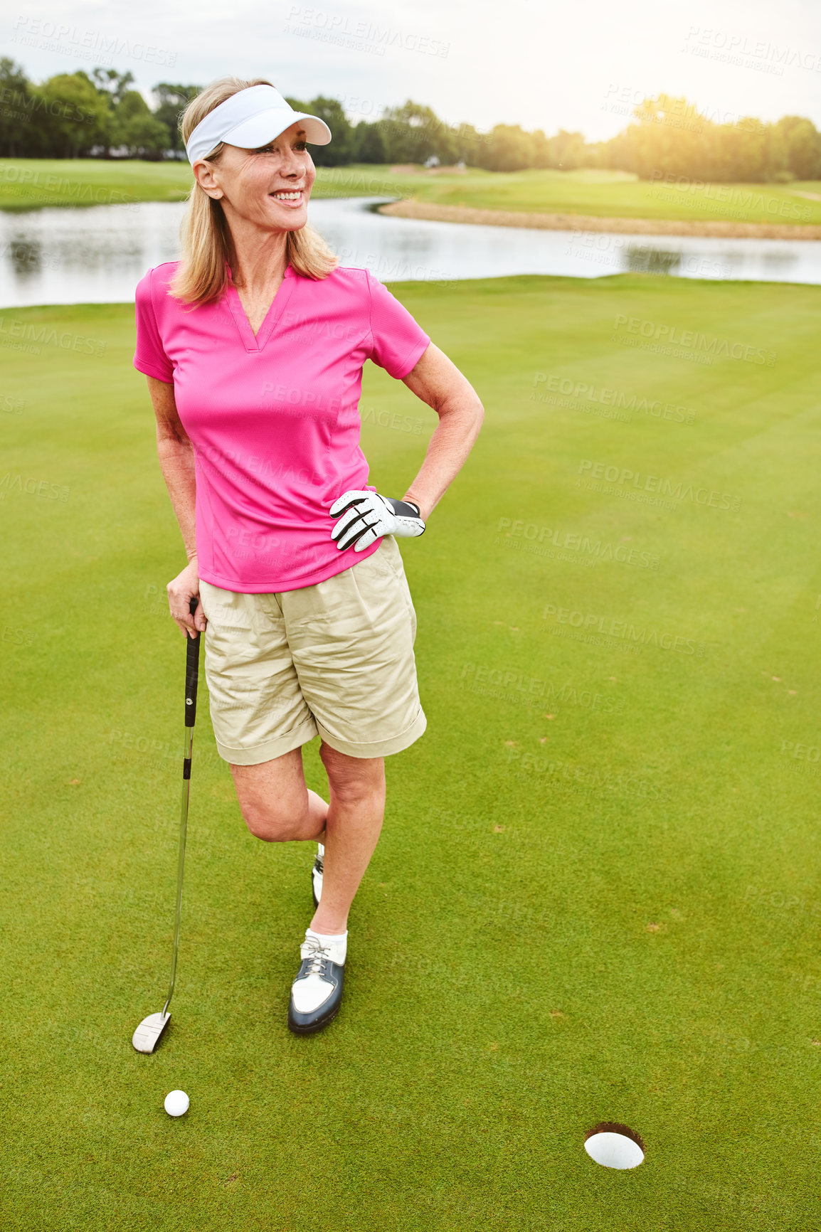 Buy stock photo Full length shot of a mature woman out playing golf on a golf course