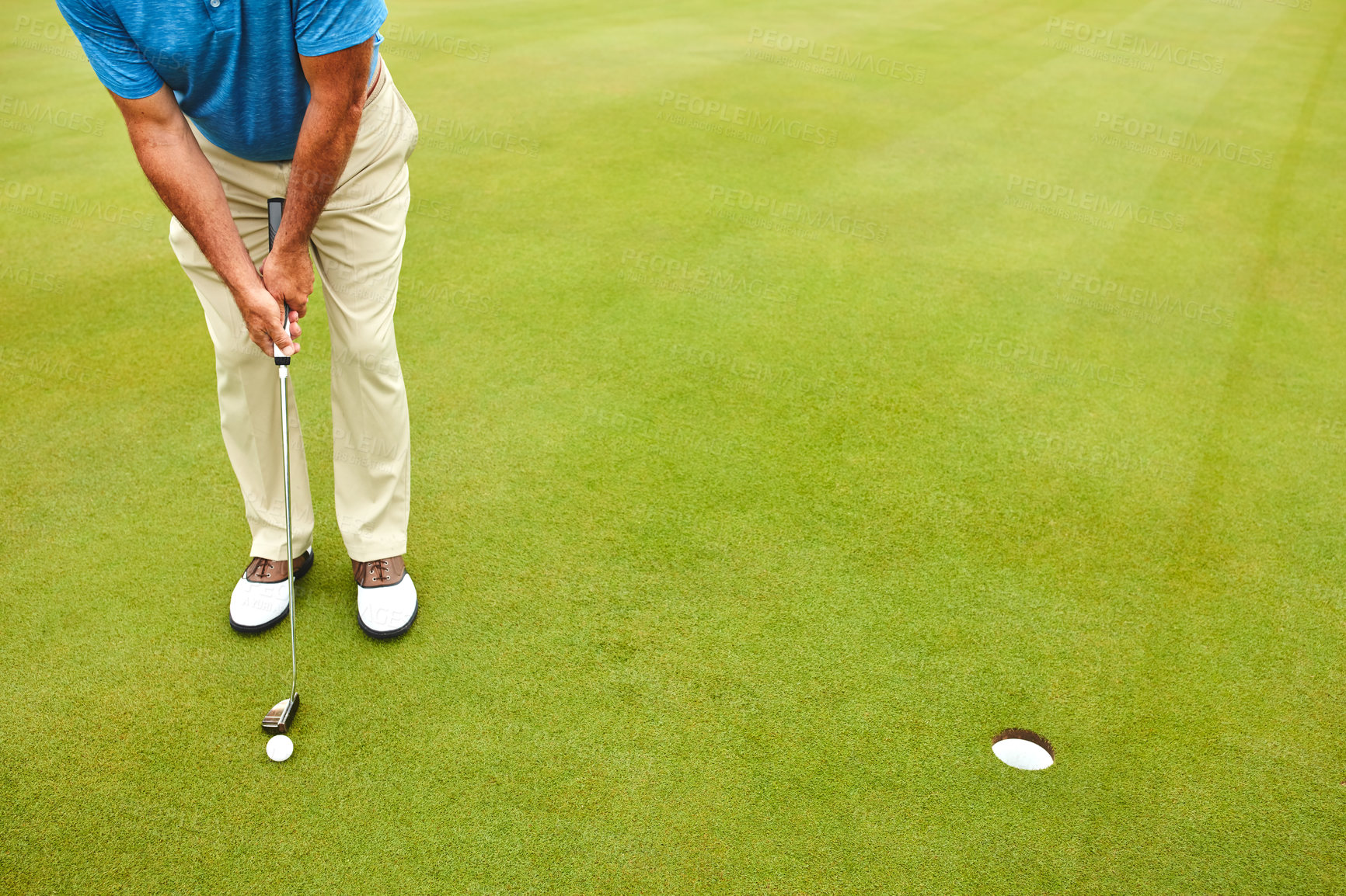 Buy stock photo Shot of a mature man out playing golf in his free time