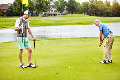 Buy stock photo Shot of two friends out playing golf together in their free time