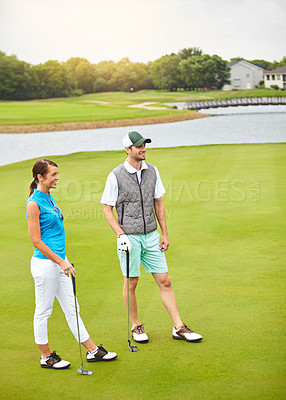 Buy stock photo Full length shot of a young couple out on the golf course