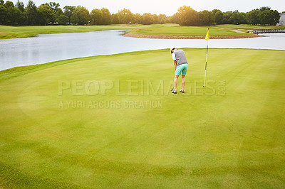 Buy stock photo Shot of a young man out playing golf on the golf course