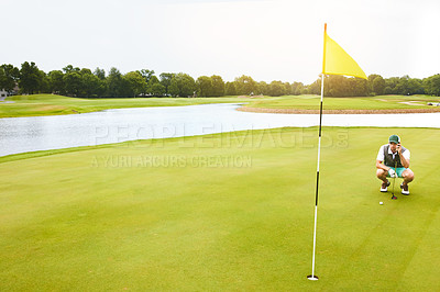 Buy stock photo Shot of a young man out playing golf on the golf course