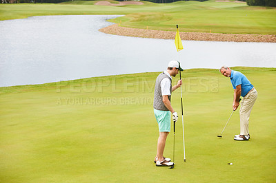 Buy stock photo Men, golf course and playing on field for tee off as members in club for health, wellness or business. Male people, putter and hole for sports, exercise or goal for meeting as partner in company