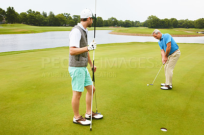 Buy stock photo Men, golf course and game for tee off in morning as members in club for health, wellness or fitness. Male people, putter and hole for sports, exercise or challenge as friends in outdoor for workout