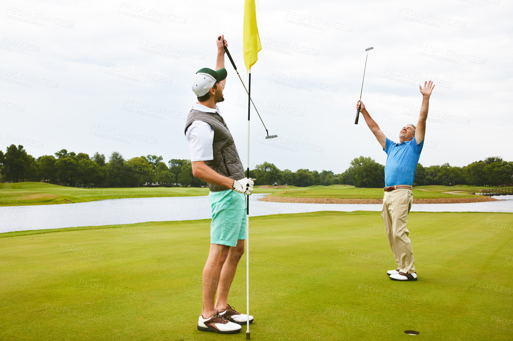 Buy stock photo Men, golf and win in celebration for eagle in tee, field as member in club for health, wellness or fitness. Male people, putter and hole for sport, exercise or workout as friends in challenge or game