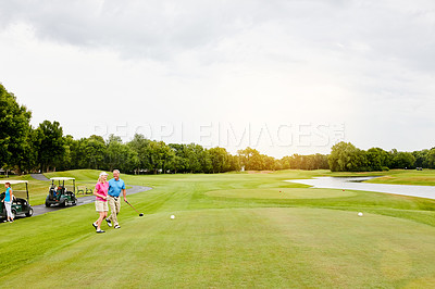 Buy stock photo Shot of a mature couple out playing golf together