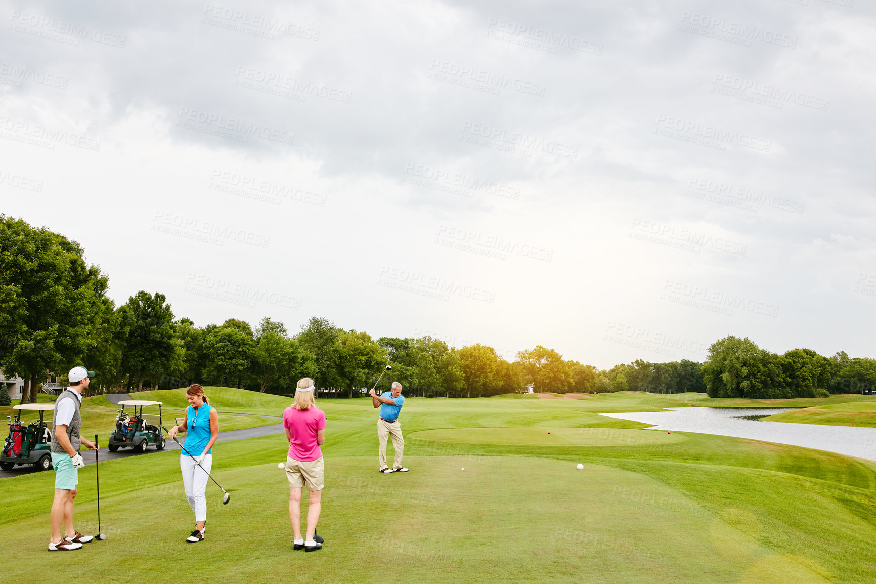 Buy stock photo Shot of four people out on a double date on a golf course