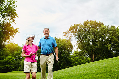 Buy stock photo Mature, couple and walking on golf course, outside and healthy fitness activity with golfers together with club. Relaxing, weekend break and happy with smile for sport, nature exercise and people