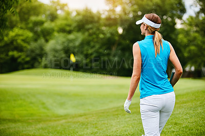 Buy stock photo Shot of a woman on a golf course