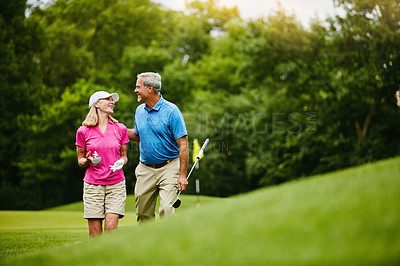 Buy stock photo Mature, people and walk on golf course, outside and healthy fitness activity with golfers together with club. Relaxing, weekend break and happy with smile for sport, nature exercise and couple