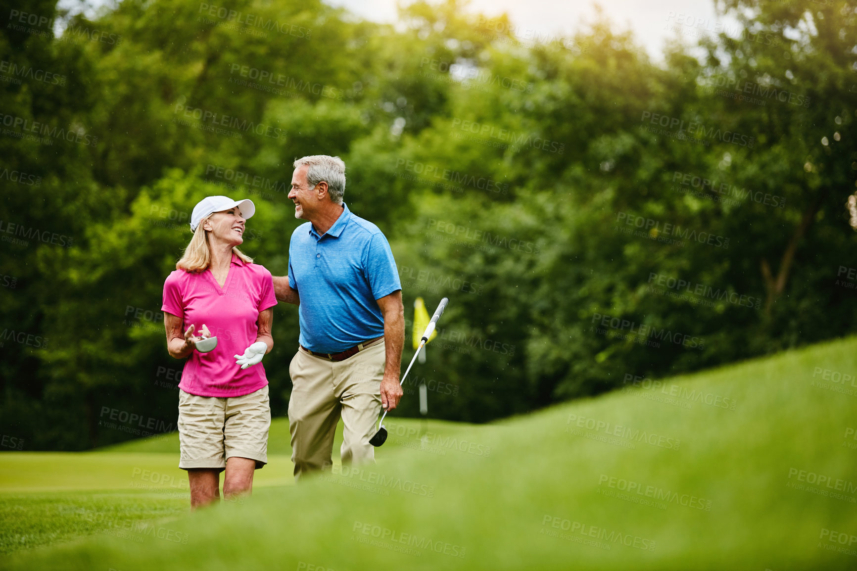 Buy stock photo Mature, people and walk on golf course, outside and healthy fitness activity with golfers together with club. Relaxing, weekend break and happy with smile for sport, nature exercise and couple