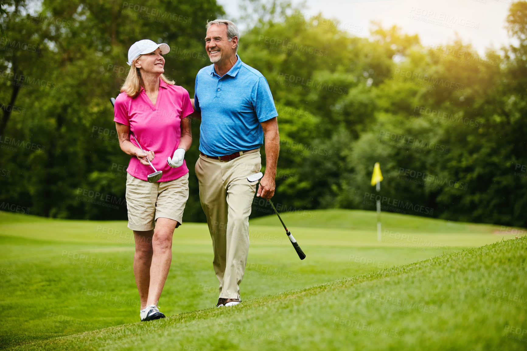 Buy stock photo Mature, couple and walk on golf course, outside and healthy fitness activity with golfers together with club. Relaxing, weekend break and happy with smile for sport, nature exercise and people