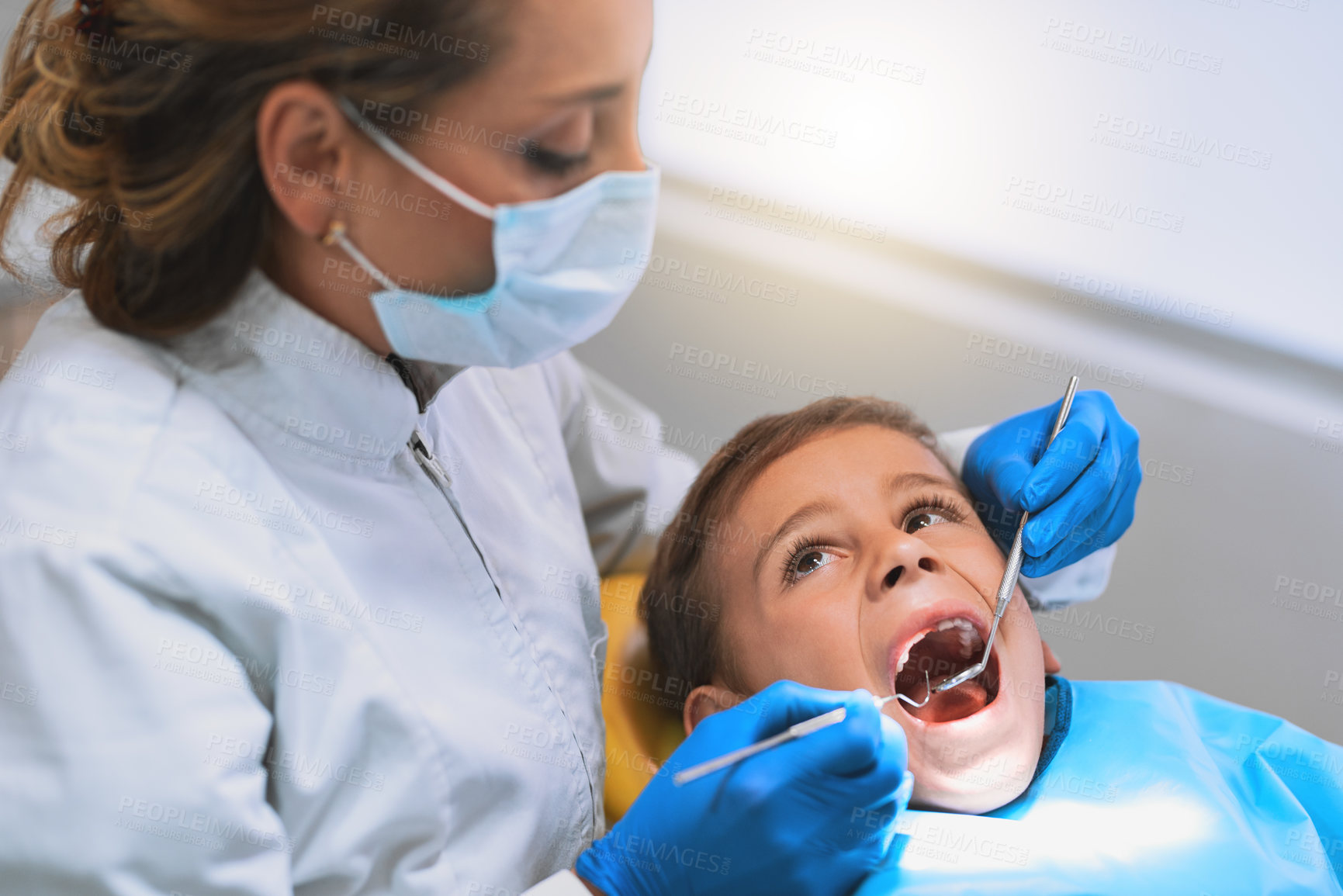 Buy stock photo Child, dentist and consultation for checkup in hospital for procedure or examination in oral care clinic. Woman, patient and mask with tools as orthodontist for teeth cleaning or root canal treatment