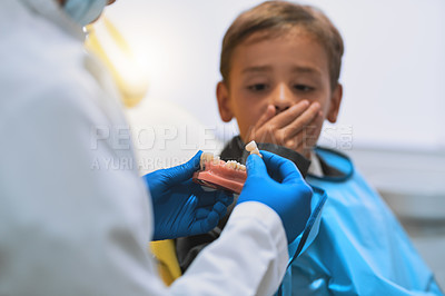 Buy stock photo Teeth, surprise and child in office, dentist and shock of education, cavity and hands of doctor with boy. Healthcare, demonstration and dental model for info, oral hygiene and wellness of mouth