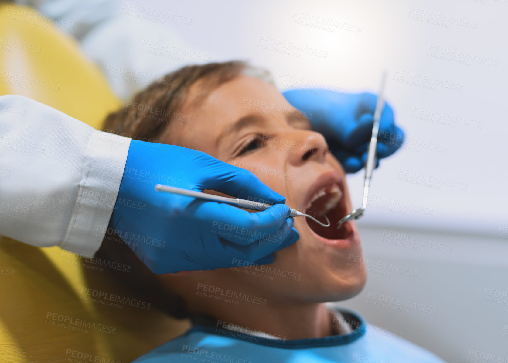 Buy stock photo Hands, kid and dentist with tools for cleaning teeth, checkup and oral hygiene at pediatric clinic. Boy, gloves or orthodontics treatment for tooth, closeup and dental health with excavator or mirror