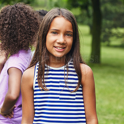 Buy stock photo Shot of a young girl hanging out with her friends in the park