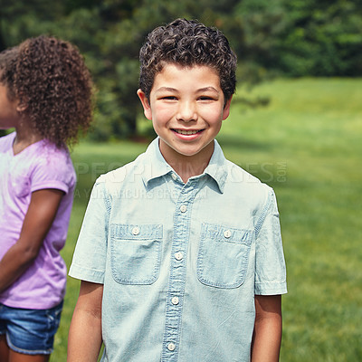 Buy stock photo Shot of a young boy hanging out with his friends in the park