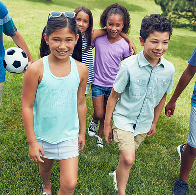 Buy stock photo Shot of a group of young friends hanging out together in the park