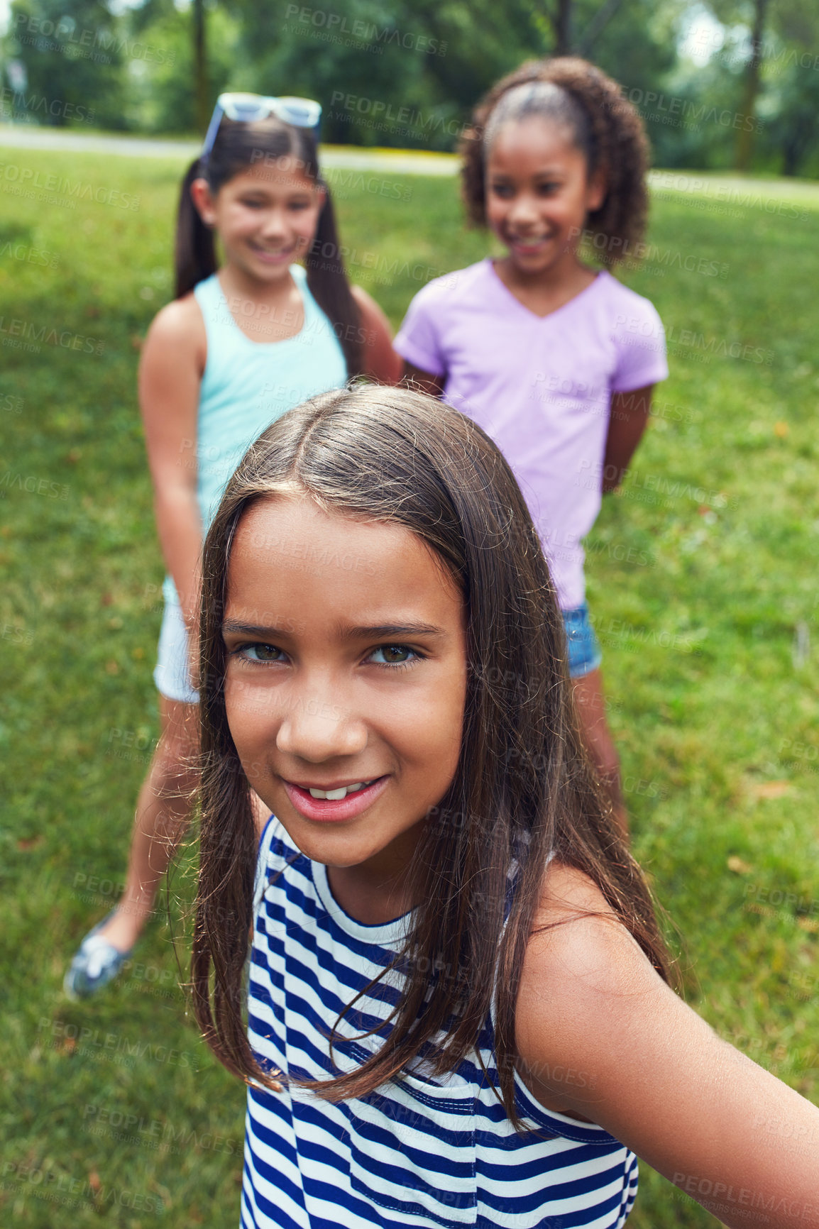 Buy stock photo Shot of a young girl hanging out with her friends in the park