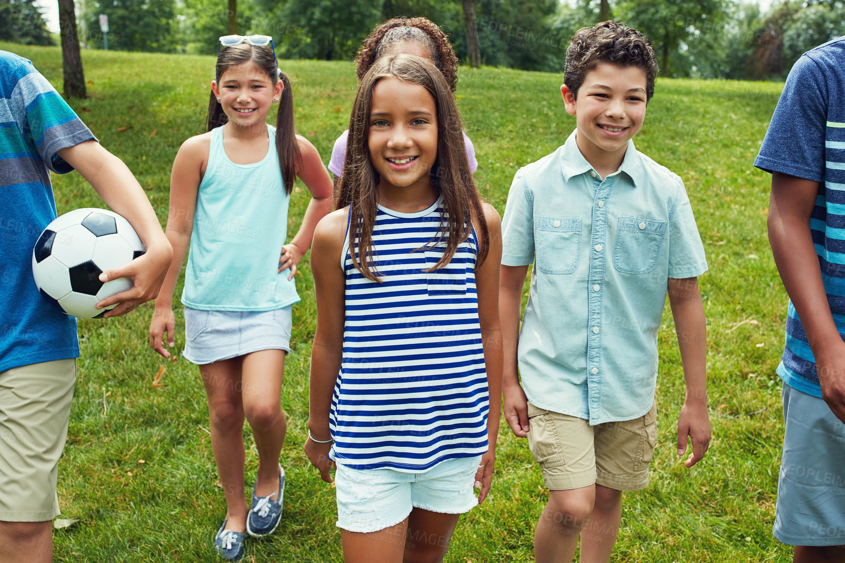 Buy stock photo Shot of a group of young friends hanging out together in the park